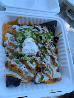 vegan nachos with cashew cheeze, ranch dressing, bbq sauce etc. at Flourish Plant-Based Eatery in Evansville