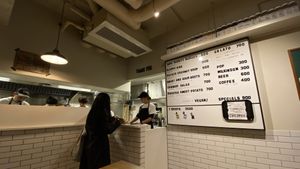 Menu (subject to change) and kitchen at Superiority Burger in Tokyo