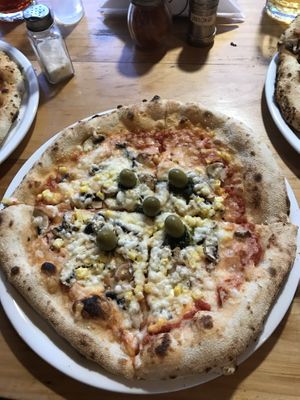 vegan pizza with green olives, mushroom, sweetcorn and garlic  at Pizzeria Napoli in Puerto Natales