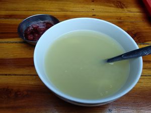 Quinoa and potato soup with a strawberry dessert behind it at Govinda Gopal - Govindas  in Quito