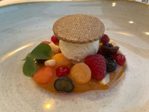 Fruit dessert with mango mousse, coconut icecream and gluten free buckwheat cookie.  at Paradiso Pure Living Vegan Hotel in Kastelruth