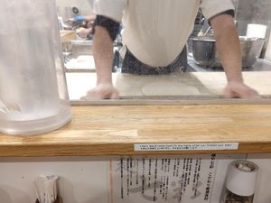 Chefs preparing the ramen in front of you at Menya Shichisai in Tokyo