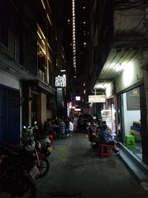 Head down the alley past these restaurants at Sugam Vegetarian in Bangkok