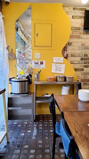 Self service counter with free side dishes, e.g. kimchi and barley rice at Saenggak Boda Masitneun Jip in Seoul