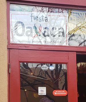 Happy cow decal on door but hard to see at Fiesta Oaxaca in Santa Fe