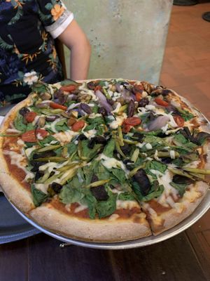 Veggie pizza with jalapeño dough (tomatoes, spinach, asparagus, olives, mushrooms) at La Masa Pizzería Conceptual in San Juan