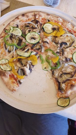 Pizza with vegan cheese at La Rucola in Tenerife