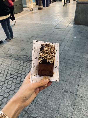 Vegan chocolate popsicle covered in dark chocolate coating and peanuts  at Loco Polo in Sevilla