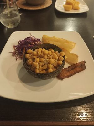 Garbanzos al ajillo con yuca frita (garlic chickpeas with fried yucca on the side. It comes with red cabbage salad and a slice of sweet plantain at El Trapiche in Panama City