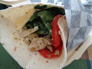 Pesto Chick'n Wrap. Shredded pesto chick'n on a tortilla with smoked provolone, pesto mayo, spinach, and tomato. Vegan. at Birch Cafe in Highland Heights
