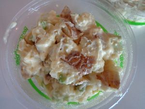 Potato salad side. Contains a mayo-like sauce, green onions, and celery. at Birch Cafe in Highland Heights