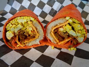 Ian's Firestarter Breakfast Burrito. Tofu eggz, sausage, vegan cheddar, pickled jalapenos, hot sauce, crispy jalapenos, and a hash brown patty wrapped in your choice of tortilla. Very spicy! at Birch Cafe in Highland Heights