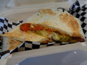 Black bean Crunchwrap special. Flour tortilla, refried beans, black beans, salsa, crispy tostada, shredded lettuce, shredded cheddar, diced tomatoes. Vegan. at Birch Cafe in Highland Heights
