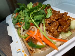 Banh Mi: Vietnamese Crusty Bread Sandwich w/ Chili Garlic Soy Protein, House-Made Mushroom & Nut Pâté, Vegan Mayo, Pickled Daikon, Carrots, Cucumber, Cilantro, Jalapeño at Loving Hut in Redlands