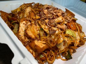 Mee Goreng: Wheat Noodles, Tofu, Cabbage, Green Onions, Stir-Fried in Spicy Indonesian Sauce, topped with Fried Onions at Loving Hut in Redlands