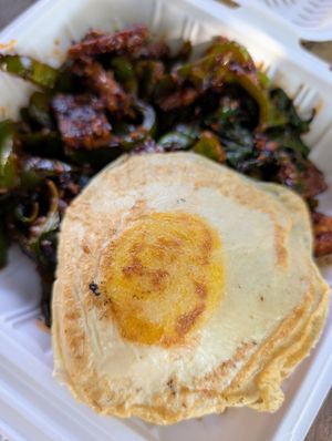 Thai dish with basil and chili tempeh and a vegan egg at Loving Hut in Redlands