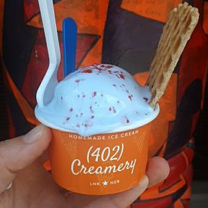 Kid's Scoop x New! July 2022 Flavor: Cotton Candy Land (GF) - cotton candy blue raspberry ice cream w/ pop rocks topping & complimentary/complementary made-from-scratch waffle chip at (402) Creamery in Lincoln
