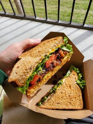 Buffalo chickpea sandwich with added avocado, coconut bacon, and cheeze at Life - The Vegan Drive Thru in Cape Coral