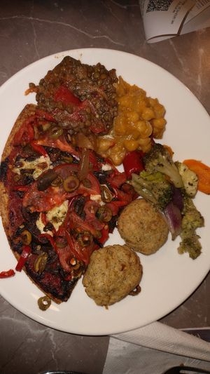 vegan whole wheat pizza with mushrooms, olives, tomatoes and cashew cream; tofu-rice bites; sweet chickpea curry; lentil stew; pan fried veggies at Paradise Food in Podgorica