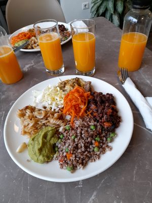 Mixed plate from the buffet with fresh orange juice at Paradise Food in Podgorica