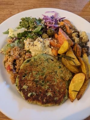 Pea and courgette fritters with salad and potato wedges at The Veg Box Cafe - Canterbury in Canterbury