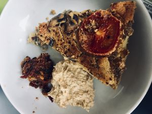 Frittata with potatoes, tomatoes and mushrooms . On the side hummus (delicious) and red pesto  at The Veg Box Cafe - Canterbury in Canterbury