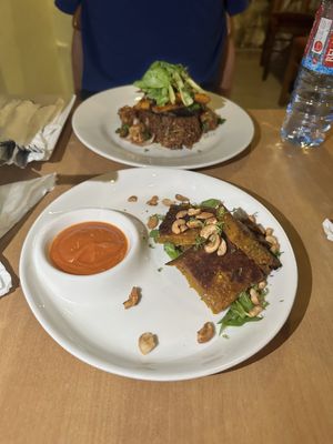 Tatale (front), Tatale Jollof rice (back)  at Tatale Vegan Restaurant in Accra