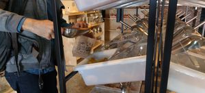 Filling paper bag with dried mangoes at Salud a Granel in Tijuana