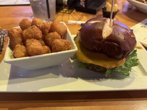 Impossible burger with vegan muenster cheese added and tater tots as a side  at Hoptinger Beer Garden - Riverside in Jacksonville
