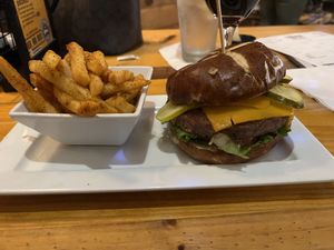 Impossible burger with vegan muenster cheese added with a side of fries  at Hoptinger Beer Garden - Riverside in Jacksonville