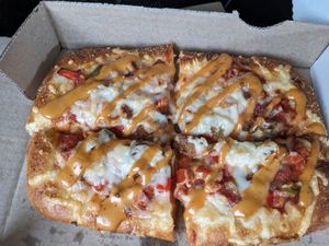 Custom pizza with sausage, pepper and onions, and chipotle drizzle at 4th & State in Columbus