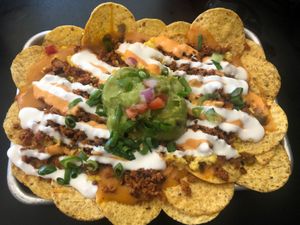 Brunchos-breakfast nachos with just egg, chipotle sauce, cheese sauce, sour cream, green onions, soyrizo, guacamole (1/2 order) at 4th & State in Columbus