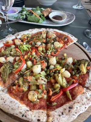 Vegan böregi (almost finished) in the back. Very good! Vegan pizza in the front, also real good    at Keyif in Goreme