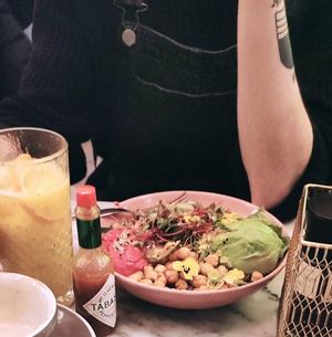 Buddha bowl of chickpea, beet hummus, quinoa, avocado and some salad. Also fresh juice lf orange, banana and mint. at Basilio in Lisbon