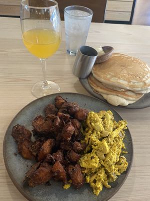 Mushroom scramble with crispy potatoes, short stack and mimosa . I added some cashew queso and all together is DELICIOUS!  at Bearcat Cafe - CBD in New Orleans