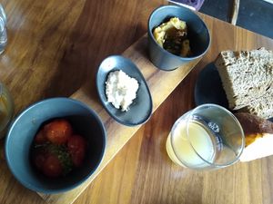 Breakfast: Sourdough bread, lye croissant, with sweet rusted tomatoes and lentil hummus at Leuchtendroter in Frankfurt