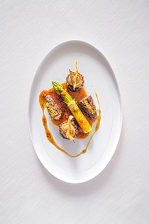 Green asparagus from Pertuis, tarragon tomato jus, roasted artichokes, morels and mushroom cream at Lafleur in Frankfurt