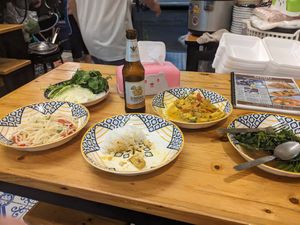 Papaya salad (cabbage and herbs behind), rice, yellow curry, fried morning glory at Markintiny in Bangkok