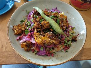 Cauliflower flatbread, slaw, hummus , taboulee, pom seeds. at Boston Tea Party in Taunton