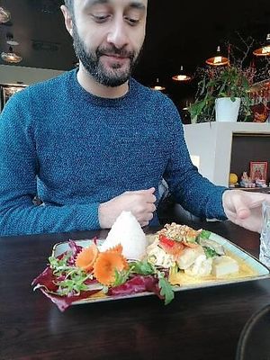 My friend getting ready for his curry at KIM999 in Berlin