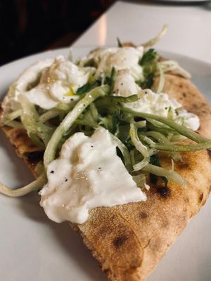 Pizza with roman vegetable (called puntarelle) and burrata (special kind of mozzarella) at la Cucina di Pastella in Rome
