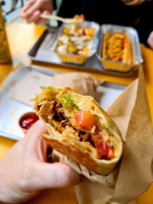 kebap wrap, loaded fries and hot dog in the background at Furahaa - Vegan in Paris