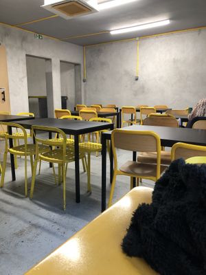 Simple functional upstairs seating  at Furahaa - Vegan in Paris