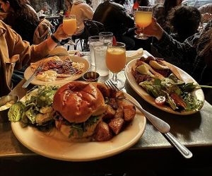 Vegan JUST egg sandwich with impossible sausage and avo on the right    at Bonjour Cafe in Boston