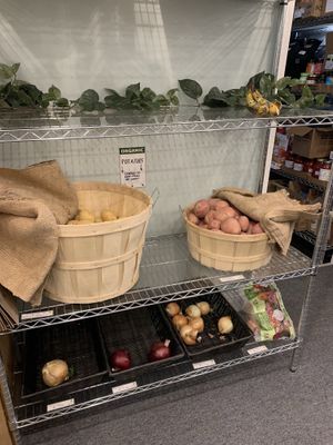 Potatoes, onions and bananas at The Local Food Market in Tully