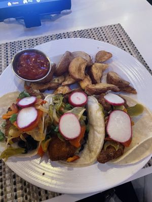 Fried avocado breakfast tacos.  Added fajitas and black beans to my order at no charge  at IAH -El Premio - Terminal E in Houston