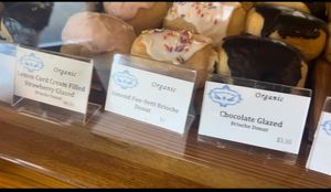 Lemon curd strawberry glazed, almond fun-fetti, and chocolate glazed brioche donuts.   at Breads On Oak - Carondelet St in New Orleans