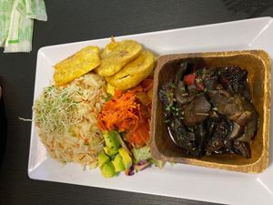 Sautéed mushrooms in wine with rice pilaf and salad.   at Antojitos Veganos in Bayamon