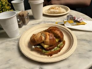 bloom benedict vegan sandwich, vegan potato egg and cheese wrap in the background  at Bloom Cafe in Staten Island