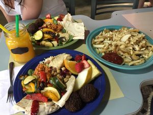Falafel plate + 'side' of garlic fries. The portions here are outta this world!  at Karine's in Toronto